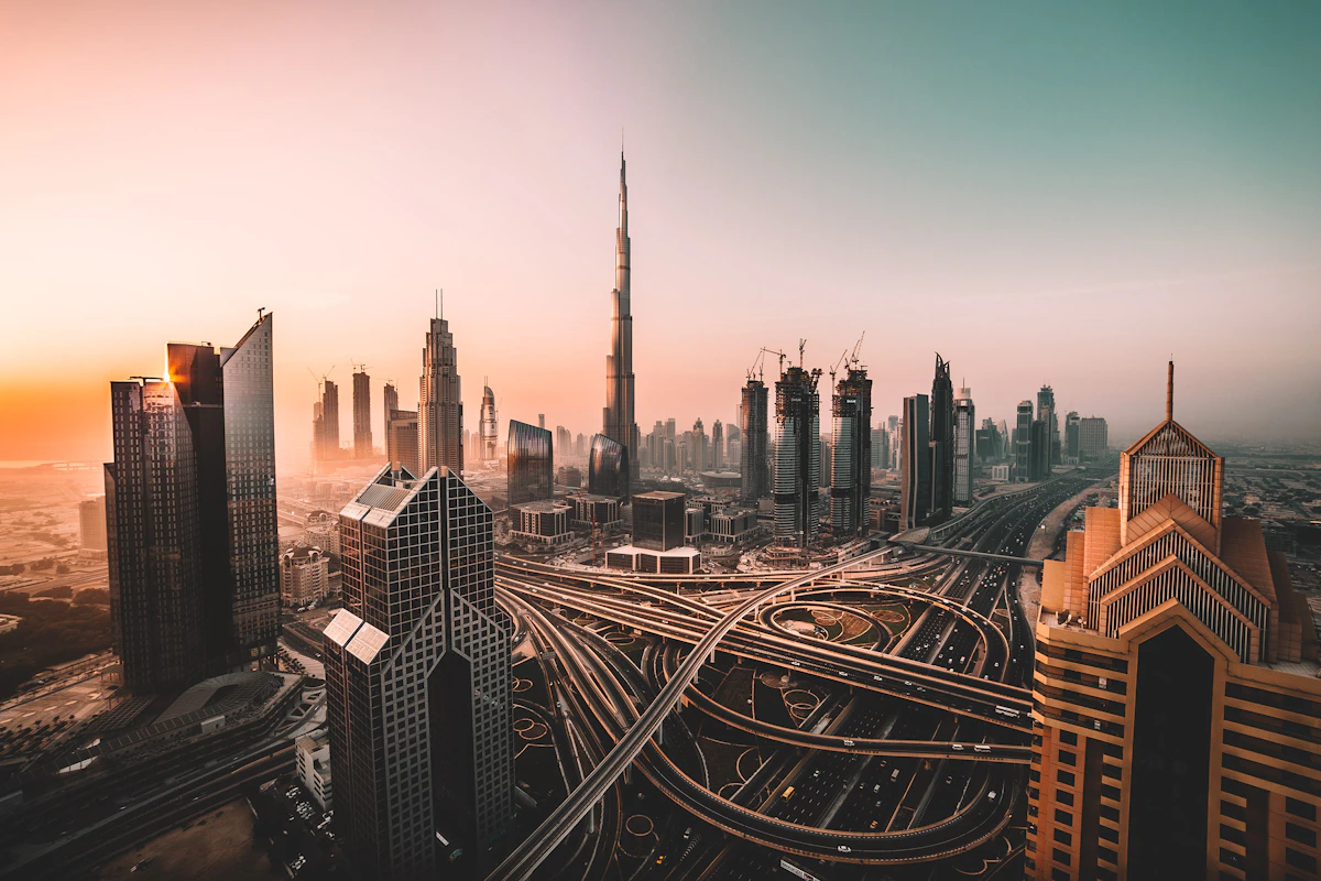Dubai skyline with Burj Khalifa and a highway interchange in warm evening light