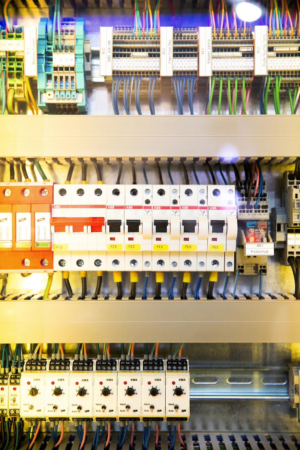 Circuit breakers, cable terminals and wiring inside an electrical control cabinet